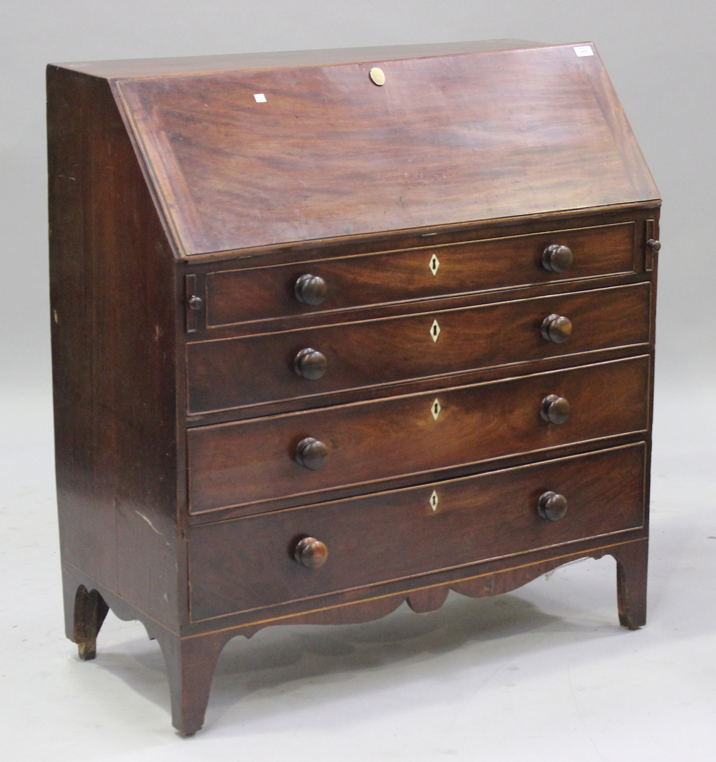 A George III mahogany bureau, the fall flap above four graduated long drawers, on bracket feet,