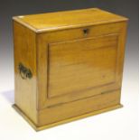 An Edwardian oak stationery box, the hinged lid and fall front enclosing a letter rack and writing