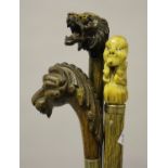 A late 19th century walking stick, the oak handle carved as a stylized lion's head with inset