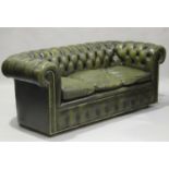 A pair of 20th century buttoned green leather Chesterfield settees, supported on castors, height