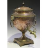 An early 19th century copper and brass mounted samovar, fitted with ram's mask ring handles,