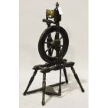 An early 20th century stained walnut spinning wheel with turned and block supports, height 95cm.