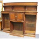 An Edwardian walnut bookcase cabinet by 'Collinson & Lock London', the shelf back above central