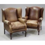 A pair of late 20th century brown leather wing back armchairs by Laura Ashley, on cabriole legs,