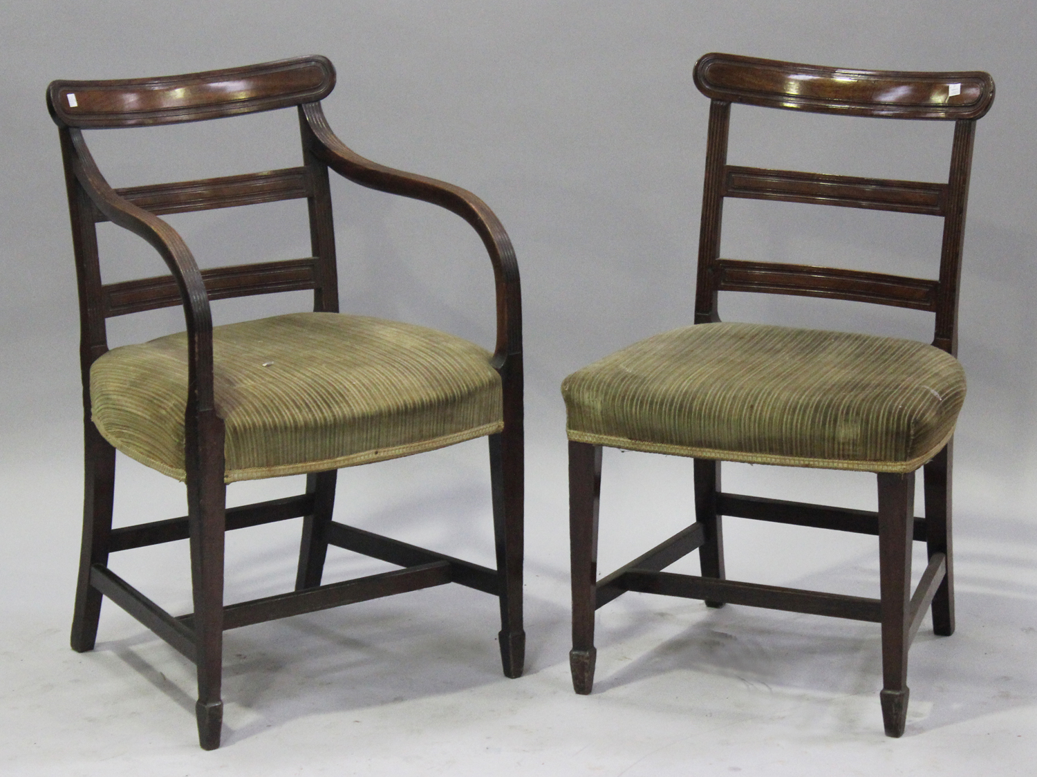 A set of eight George IV mahogany bar back dining chairs with padded seats, raised on square