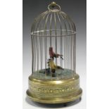 A 20th century brass musical birdcage automaton, the wirework cage enclosing two feathered birds,