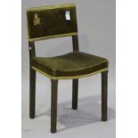 A George VI oak framed coronation chair, the upholstered seat and back raised on chamfered block