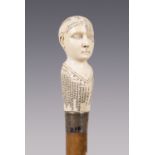 An early 20th century phrenology walking stick, the carved ivory handle finely modelled as a