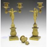 A pair of Regency gilt bronze twin light candelabra, each with a full-length angel stem and ogee