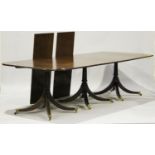 A 20th century Regency style mahogany triple pillar dining table with two extra leaves, on turned