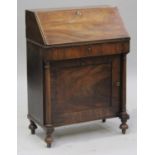 A small Regency mahogany bureau, the fall flap above a drawer and a panelled cupboard door,