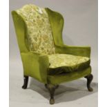 A late 19th/early 20th century wing back armchair, on carved cabriole legs, height 116cm, width