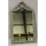 A 19th century French Rococo Revival grey painted wood and gesso pier mirror with scroll surmount,