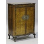 An early 20th century Queen Anne style walnut serpentine fronted side cabinet, on carved cabriole