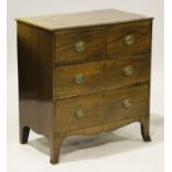 An early 19th century mahogany chest of two short and two long drawers, on splayed bracket feet,