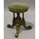 A Victorian Aesthetic period walnut revolving piano stool, on tripod legs, height 48cm, diameter