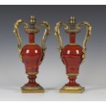 A pair of early/mid-19th century cast ormolu and lithyalin twin handled ornamental vases, the ogee