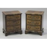 A pair of late 20th century reproduction mahogany bedside chests of three drawers, on bracket