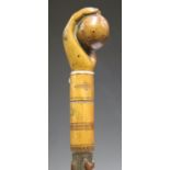 An unusual 19th century carved maple walking stick handle and partial shaft, the handle in the