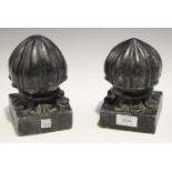 A pair of late 19th century Indian carved black stone carpet weights of reeded finial form, height