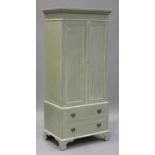 A late 20th century painted pine wardrobe, fitted with a pair of panel doors above drawers, on