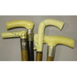 A group of four Victorian ivory handled walking sticks, one carved with a country man and his dog (