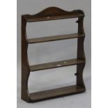 A Victorian mahogany four-tier wall shelf with a shaped gallery, height 82cm, width 62cm.Buyer’s