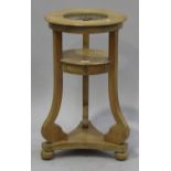 A 20th century Continental pine washstand, the ring top raised on scrolling tripod supports,