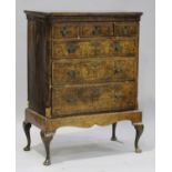 A George I walnut chest of three short and three graduated long drawers with feather banded and