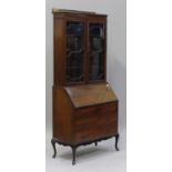 A George V mahogany bureau bookcase with overall chequer stringing, the glazed top above a fall