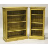 A graduated pair of modern pine open bookcases, fitted with adjustable shelves, on plinth bases,