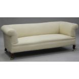 An early 20th century Chesterfield settee, upholstered in cream fabric, raised on cabriole legs