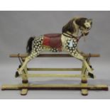 An early 20th century dapple grey rocking horse with amber and black eyes, mane, tail and saddle,