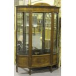 An Edwardian mahogany and boxwood line inlaid serpentine fronted display cabinet, fitted with a