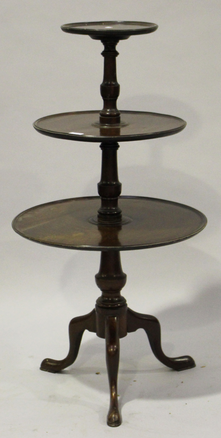 A 19th century mahogany three-tier graduated dumb waiter with a turned support and tripod legs,