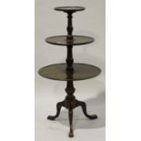 A 19th century mahogany three-tier graduated dumb waiter with a turned support and tripod legs,