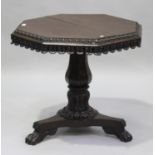 A Regency mahogany octagonal centre table, the top with a bead and reel edge above a stiff leaf