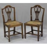 A set of six George III provincial elm dining chairs with carved and pierced splat backs above