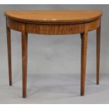 A George III satinwood demi-lune fold-over card table with inlaid decoration, on square tapering