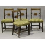 A set of four George IV mahogany bar back dining chairs with overstuffed seats, on square tapering