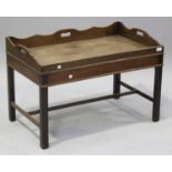 A 20th century mahogany butler's tray-top coffee table, the galleried top raised on block legs,