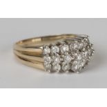 A 9ct gold and diamond ring, claw set with three rows of seven circular cut diamonds graduating in