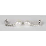 A pair of diamond and freshwater cultured pearl pendant earrings, each freshwater cultured pearl