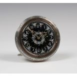 An Edwardian silver and parcel gilt circular cased boudoir timepiece, the black enamel dial with