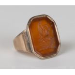 A gold mounted cornelian signet ring, carved with a bird and three chicks in a basket crest, ring