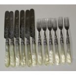 A set of six Victorian silver and mother-of-pearl handled fruit knives and forks with engraved