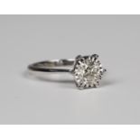 An 18ct white gold and diamond single stone ring, claw set with a round brilliant cut diamond,
