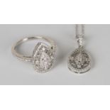 An 18ct white gold and diamond ring in a filigree pear shaped design between diamond set