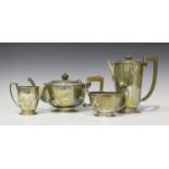 An Art Deco silver three-piece tea set, each raised on a stepped circular foot, comprising teapot,