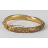 An Italian gold oval hinged bangle, applied with filigree decoration, the front detailed 'Roma',